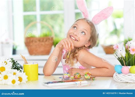 Portrait Of Beautiful Girl Painting Eggs For Easter Holiday Stock Photo