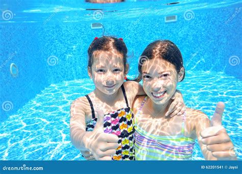 Children Swim In Pool Underwater Girls Have Fun In Water Stock Image