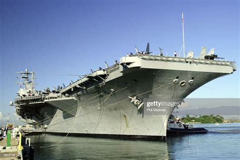 The Aircraft Carrier Uss Nimitz Is Pushed Into Port By Tug Boats At