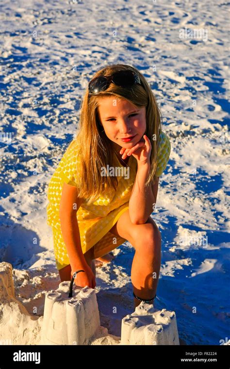 Young Girl Posing At Sunset By The Sand Castle She Built On Siesta Key