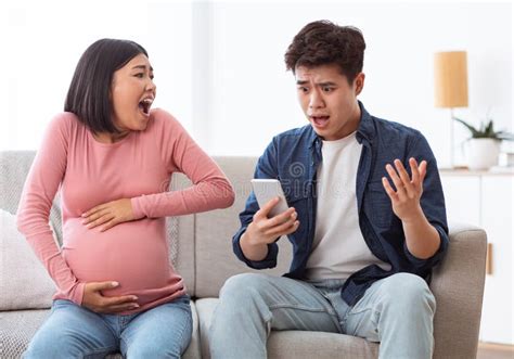 Shocked Asian Husband Calling Emergency For Pregnant Wife At Home Stock Image Image Of Call