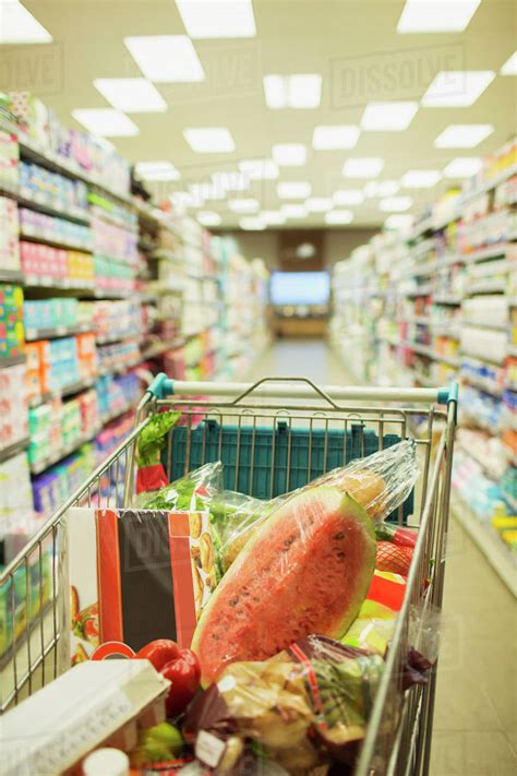 Full Shopping Cart In Grocery Store Aisle Stock Photo Dissolve