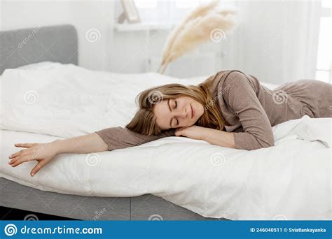 Beautiful Woman Wakes Up In Her Bed Smiles And Stretches Stock Image
