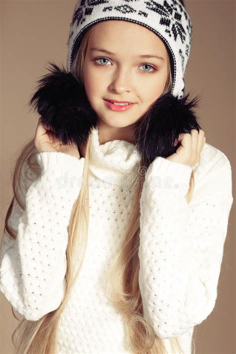 Beautiful Little Girl With Long Blond Hair In Cozy Knitted Clothes