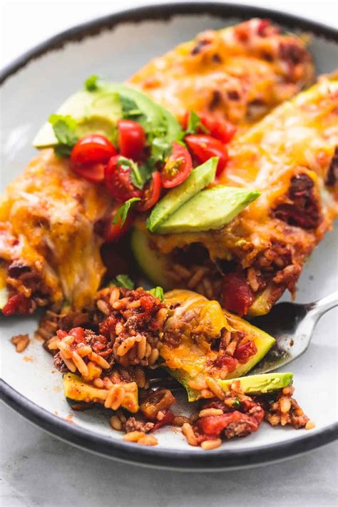 This savory and spicy taco recipe replaces the tortillas with zucchini boats! Easy Taco Stuffed Zucchini Boats - Cravings Happen