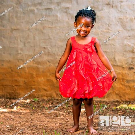 Full Length Portrait Of Cute African Girl Showing Red Dress Outdoors