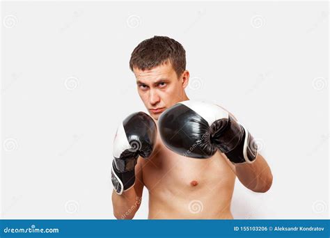A Man In Boxing Gloves With Bruises On Body And Face Stabs During A