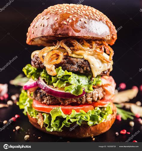 Download Juicy Delicious Burger With Spices On A Black Background — Stock Image Making
