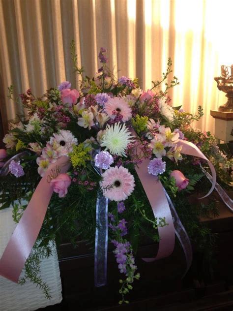 beautiful mix of soft pinks and lavenders casket spray funeral flowers funeral flower