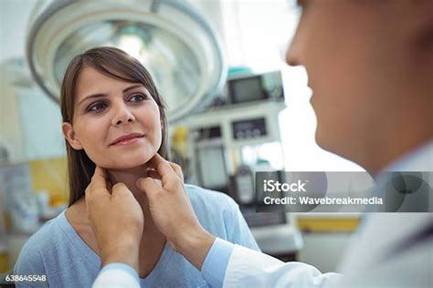 Doctor Examining A Female Patients Neck Stock Photo Download Image