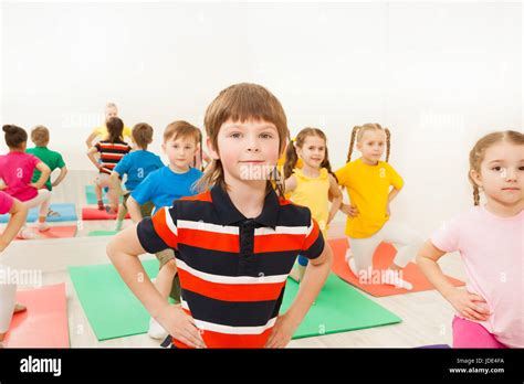 Portrait Of Caucasian Six Years Old Boy Doing Kneeling Exercises During