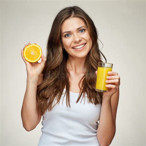 Smiling Woman Holding Orange Juice Glass With Half Orange Fruit Stock