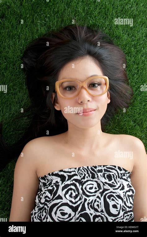 Cute Asian Girl Laying On The Green Grass Stock Photo Alamy
