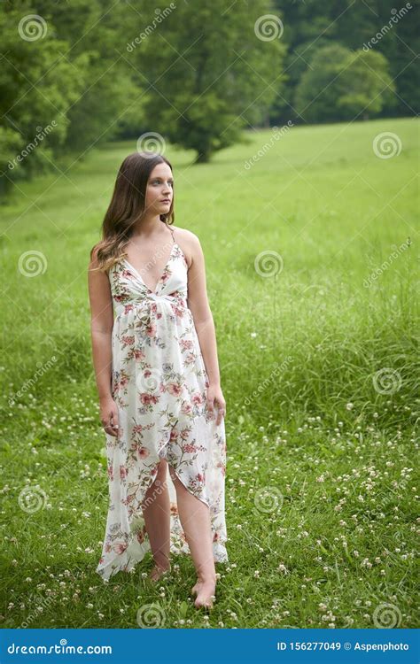 Beautiful Young Woman Walking In Sundress In Field Of Grass Stock Image