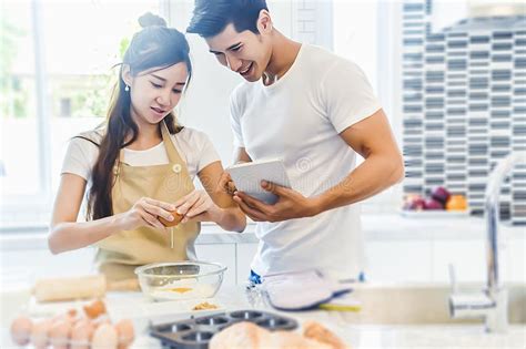 asian couples cooking and baking cake together in kitchen room stock image image of caucasian