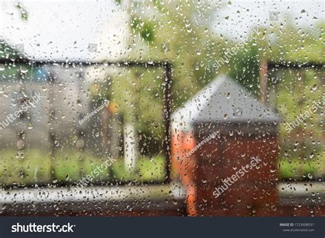 Raindrops On Window Pane Blurred Background Stock Photo 1723908031