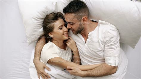 Young Beautiful And Loving Couple Kiss And Hug Into Bed While Waking Up