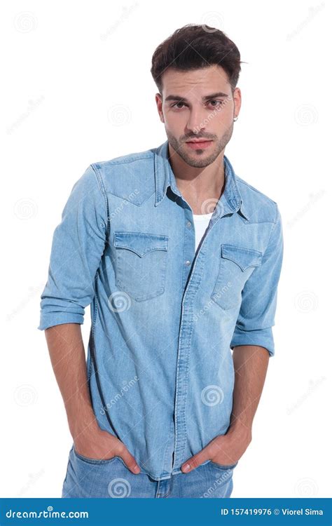 Attractive Young Man Wearing Denim Posing With Hands In Pockets Stock