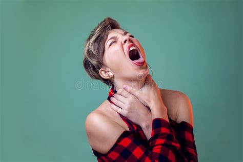 People And Emotions A Portrait Of Woman With Short Hair Choking Herself For Fun Holds Hands