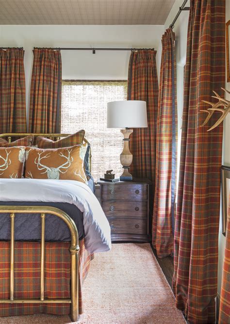 Bedroom Layered In Plaid And Accentuated With Stag Prints And Horns