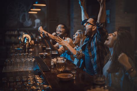 Dazn is available on smart tvs, game consoles, connected devices, smartphones, tablets, computers, and more. Group Of Disappointed Fans Watching A Sports Game On Tv In ...