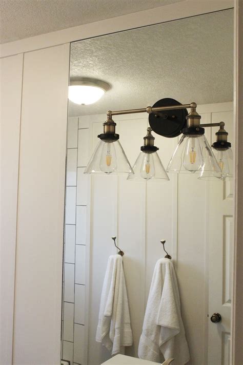 Bathroom mirror installation requires much more than pounding a nail into the wall. How to Mount a Light On Top of a Mirror Bathroom Vanity