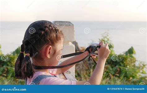 Asian Girl Holding Camera Taking A Picture With Travelling Smilling
