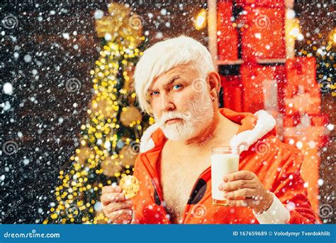 Christmas Santa Claus Enjoys Cookies And Milk Left Out For Him On Christmas Eve Stock Image