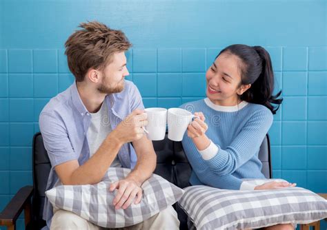 Two People Couple In Living Room Enjoy With Drink Coffee Stock Image