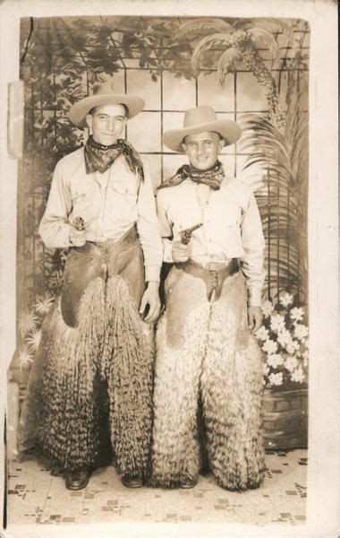 Two Men Dressed As Cowboys Wearing Wooly Chaps Holding Pistols Men