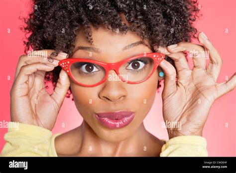 Portrait Of An African American Woman Wearing Retro Style Glasses Over Colored Background Stock