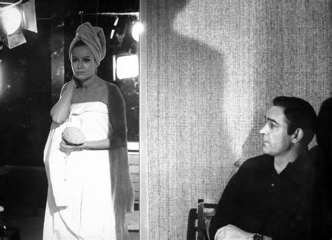 A Black And White Photo Of A Woman In A Towel Standing Next To A Man Wearing A Turban