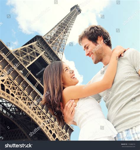 Paris Eiffel Tower Romantic Couple Embracing Kissing In Front Of Eiffel