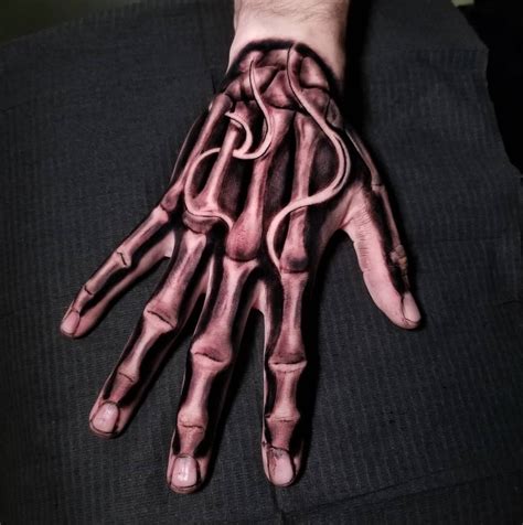 32 Creepy Cool Skeleton Hand Tattoos