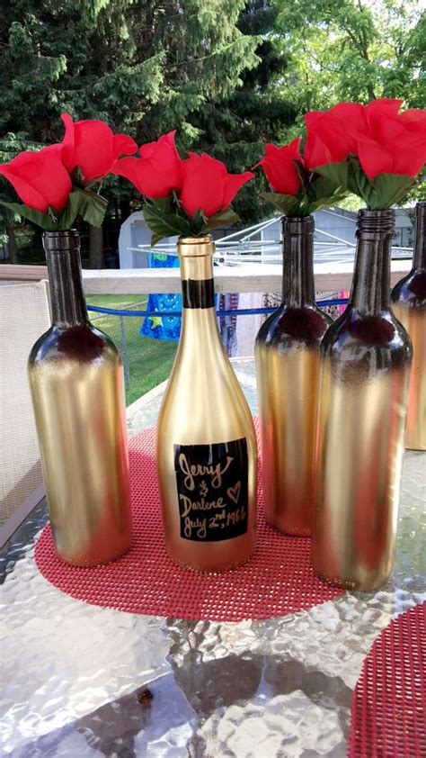 Add some color to your outdoor ceremony by hanging painted wine bottles from an overhead tree (this also makes a striking ceremony backdrop). Black and gold ombre, spray painted wine bottles. These ...