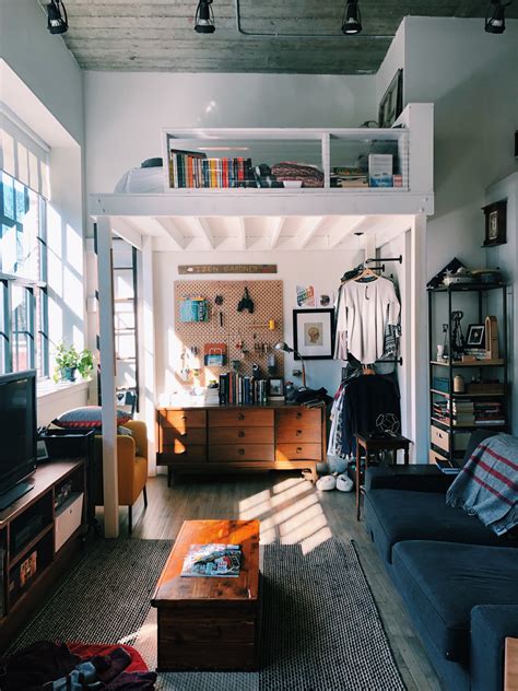 High up on the wall there is a row of cabinets for things you don't need daily, like files and bedding. A Small Boston Studio Apartment Has One of the Best DIY ...