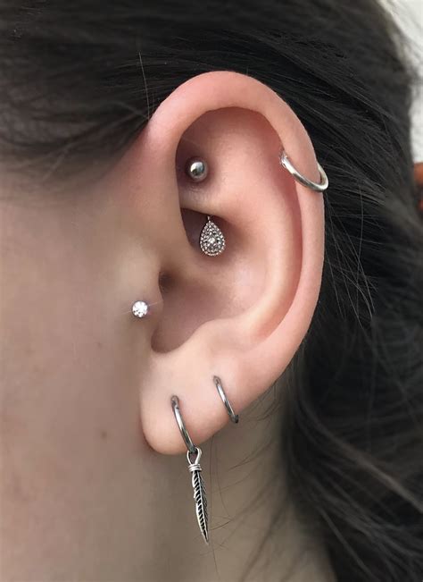 A Close Up Of A Person With Ear Piercings On Their Left And Right Sides
