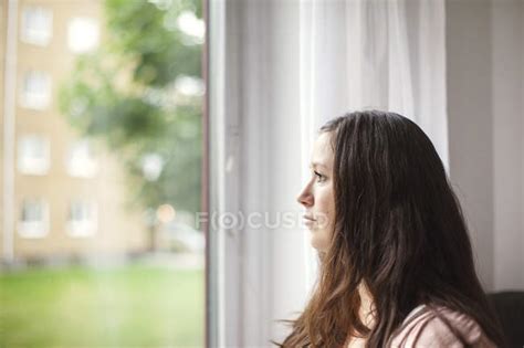 Woman Against Window — Curtain Mid Adult Stock Photo 151913404