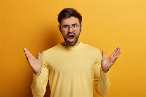 Free Photo Emotional Annoyed Man Spreads Palms And Exclaims With
