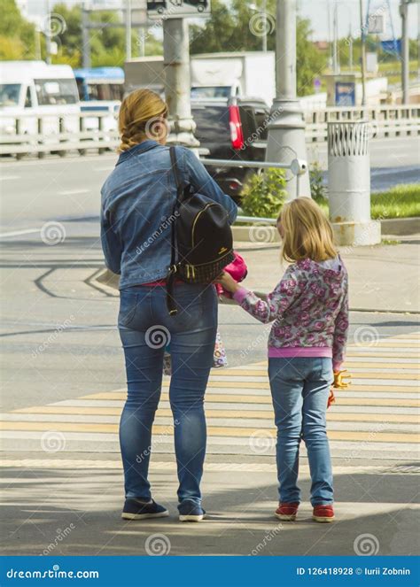 Mother And Daughter Are On The Pedestrian Crossing Editorial Stock