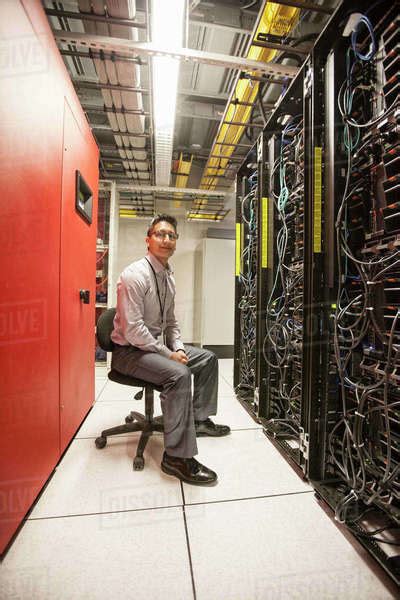 Caucasian Man Technician Working With Computer Servers In A Computer