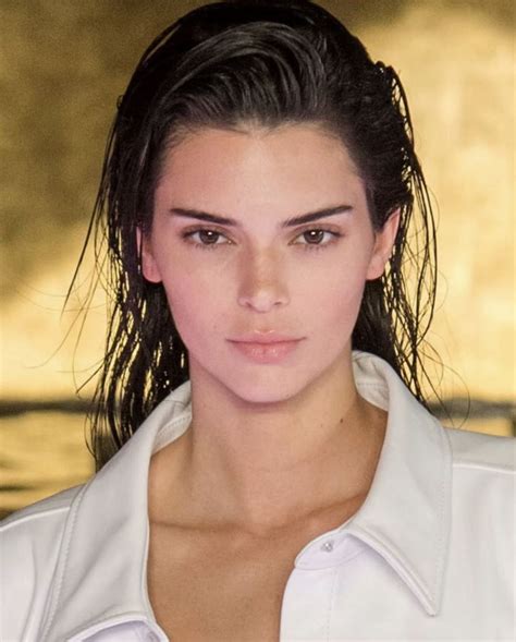 A Close Up Of A Person Wearing A White Shirt And Hair In A Ponytail With Long Bangs