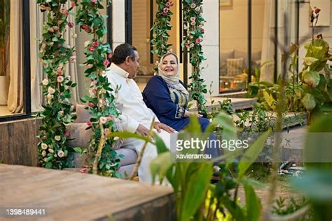 Mature Middle Eastern Couple Enjoying Outdoor Swing High Res Stock