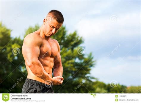 Young Bodybuilder Flexing Muscles Outdoors Stock Photo Image Of