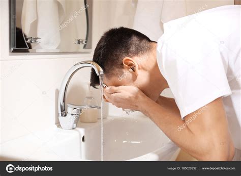Man Washing His Face After Shaving In Bathroom ⬇ Stock Photo Image By