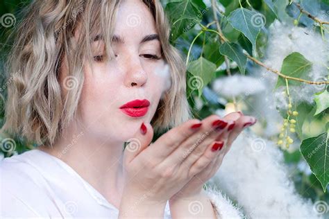 Young Attractive Freckled Girl Blows Polar Fluff Red Lips Stock Image