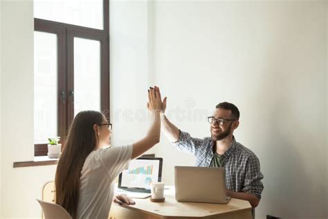 Freelance Workers Giving High Five After Successful Project Star Stock