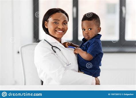 Doctor Or Pediatrician With Baby Patient At Clinic Stock Photo Image
