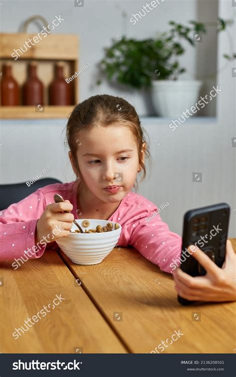 Little Girl Eating Cereal Milk Watching Stock Photo 2136208501