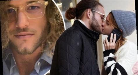 Watson donned a classic longline dark grey coat over a black knit turtleneck with black leather boots, as well as a black protective face mask and white knit hat, finishing off the look with a pop of color: Emma Watson's mystery 'boyfriend' is revealed as ...